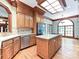 Bright kitchen featuring stainless steel appliances, hardwood floors, a skylight, and an island cooktop at 3231 Karen Ln, Monroe, NC 28110