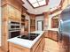 Spacious kitchen featuring an island cooktop, stainless steel appliances, hardwood floors, wood cabinets, and a skylight at 3231 Karen Ln, Monroe, NC 28110