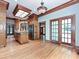 Spacious kitchen with hardwood floors, wood cabinets, stainless steel appliances, island cooktop, and access to the outdoors at 3231 Karen Ln, Monroe, NC 28110