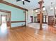 Open-concept living room featuring a fireplace, hardwood floors, and access to the kitchen at 3231 Karen Ln, Monroe, NC 28110