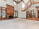 Expansive living room showcasing a fireplace, grand staircase, high ceilings, and natural light at 3231 Karen Ln, Monroe, NC 28110