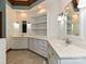 Elegant bathroom featuring dual sinks, white cabinets, and tasteful fixtures at 3231 Karen Ln, Monroe, NC 28110