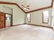 Spacious main bedroom with vaulted ceiling, decorative trim, and two windows at 3231 Karen Ln, Monroe, NC 28110