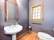 Charming powder room featuring classic fixtures, wood accents and custom wallpaper at 3231 Karen Ln, Monroe, NC 28110