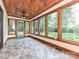 Bright sunroom with tile floors, wood ceiling, and large windows overlooking backyard at 3231 Karen Ln, Monroe, NC 28110