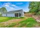 Side view of the home, highlighting the covered patio and expansive backyard at 3567 Farmfield Dr, Claremont, NC 28610