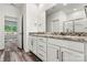 Bathroom featuring granite countertop, dual sinks, white cabinetry and wood-look floors at 3567 Farmfield Dr, Claremont, NC 28610