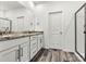 Bathroom with double sink vanity, granite countertops, modern hardware, and glass shower door at 3567 Farmfield Dr, Claremont, NC 28610