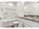 Full bathroom with white vanity, granite counters, tub-shower combo, and updated fixtures at 3567 Farmfield Dr, Claremont, NC 28610