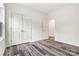 A view of a bedroom featuring wood-look flooring, double door closet, and open door to another room at 3567 Farmfield Dr, Claremont, NC 28610