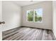 Bedroom with neutral walls, wood grain floors, and a window overlooking trees at 3567 Farmfield Dr, Claremont, NC 28610