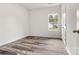 Bedroom with wood grain floors, white walls and a window overlooking the outside at 3567 Farmfield Dr, Claremont, NC 28610