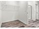 Walk-in closet featuring wood-look floors, wire shelving and access to the bathroom at 3567 Farmfield Dr, Claremont, NC 28610