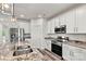 Kitchen featuring a granite island, stainless steel appliances and white cabinets at 3567 Farmfield Dr, Claremont, NC 28610