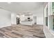 Open floor plan with wood-look floors connecting the living room and kitchen with island at 3567 Farmfield Dr, Claremont, NC 28610
