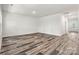 Spacious living room featuring wood-look flooring, neutral decor, and plenty of natural light at 3567 Farmfield Dr, Claremont, NC 28610