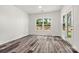 Bright room with wood-look floors, white walls, and glass door overlooking the landscaped backyard at 3567 Farmfield Dr, Claremont, NC 28610