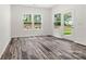Bright room with wood-look floors, white walls, and windows overlooking the landscaped backyard at 3567 Farmfield Dr, Claremont, NC 28610