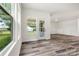Bright room with wood-look floors, white walls, and a view out to the backyard at 3567 Farmfield Dr, Claremont, NC 28610