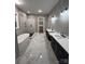 Bright bathroom with double vanity, soaking tub, and black and white tile at 3733 Whitney Ne Dr, Hickory, NC 28601