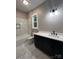 Modern bathroom featuring a tub-shower combo with marble tiling, vanity, and fixtures at 3733 Whitney Ne Dr, Hickory, NC 28601