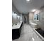 Bright bathroom with double vanity, soaking tub, and black and white tile at 3733 Whitney Ne Dr, Hickory, NC 28601