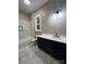 Modern bathroom featuring a tub-shower combo with marble tiling, vanity, and fixtures at 3733 Whitney Ne Dr, Hickory, NC 28601