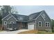Stylish home showcasing gray siding, brick accents, a two-car garage, and a welcoming entrance at 3733 Whitney Ne Dr, Hickory, NC 28601
