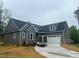 Beautiful new construction home with gray siding, brick accents, and a concrete driveway at 3733 Whitney Ne Dr, Hickory, NC 28601