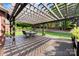Backyard featuring a spacious wooden deck covered by a pergola, ideal for outdoor dining at 3748 Tea Olive Rd, Gastonia, NC 28056