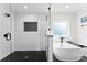 Modern bathroom featuring a walk-in shower with black hexagon tile and a freestanding soaking tub at 3748 Tea Olive Rd, Gastonia, NC 28056