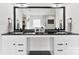 Bathroom with dual vanity, black countertop, large framed mirror, and walk-in shower in the background at 3748 Tea Olive Rd, Gastonia, NC 28056