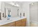 Bright bathroom with double vanity and a shower-tub combo provides ample space and convenience at 3748 Tea Olive Rd, Gastonia, NC 28056