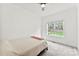 Bedroom with carpeted floors and a window overlooking the backyard at 3748 Tea Olive Rd, Gastonia, NC 28056