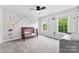 This bedroom offers carpet floors, butterfly decals, and natural light from the surrounding windows at 3748 Tea Olive Rd, Gastonia, NC 28056