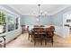 Sunlit dining room featuring elegant wood floors, crown molding and a classic chandelier at 3748 Tea Olive Rd, Gastonia, NC 28056