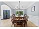 Spacious dining room with hardwood floors, large windows, and a stylish chandelier at 3748 Tea Olive Rd, Gastonia, NC 28056