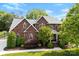 Stunning brick home with lush landscaping and a well-manicured lawn, complete with a new roof at 3748 Tea Olive Rd, Gastonia, NC 28056