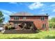 Beautiful backyard featuring a pergola-covered deck, lush lawn, and a well-maintained brick home at 3748 Tea Olive Rd, Gastonia, NC 28056