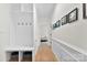 Hallway with hardwood floors, wainscoting, and a built-in storage bench at 3748 Tea Olive Rd, Gastonia, NC 28056
