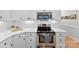 Kitchen featuring white cabinets, stainless steel appliances, marble countertops and hardwood floors at 3748 Tea Olive Rd, Gastonia, NC 28056