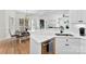 Eat-in kitchen featuring white cabinets, stainless steel appliances, marble countertops and hardwood floors at 3748 Tea Olive Rd, Gastonia, NC 28056