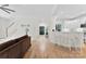 Open-concept living room with a breakfast bar, hardwood floors and white accents at 3748 Tea Olive Rd, Gastonia, NC 28056