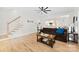 Inviting living room featuring hardwood floors, a ceiling fan, and a staircase at 3748 Tea Olive Rd, Gastonia, NC 28056