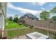 Landscaped backyard view from the deck features a well-maintained lawn, garden, and privacy fence at 3837 1St Street Nw Ln, Hickory, NC 28601