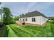 Well-manicured backyard showcasing a house with a deck and steps, surrounded by lush landscaping at 3837 1St Street Nw Ln, Hickory, NC 28601