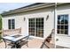 Cozy deck with sliding glass doors, lighting, and table offers a perfect outdoor relaxation space at 3837 1St Street Nw Ln, Hickory, NC 28601
