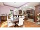 Open concept dining room with modern lighting and kitchen in the background at 3837 1St Street Nw Ln, Hickory, NC 28601