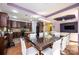 Dining area with a hardwood floor, purple accented ceiling, and views into the kitchen and living room at 3837 1St Street Nw Ln, Hickory, NC 28601