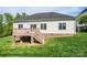 Exterior of the home with a deck and steps leading to a spacious backyard and lush green lawn at 3837 1St Street Nw Ln, Hickory, NC 28601